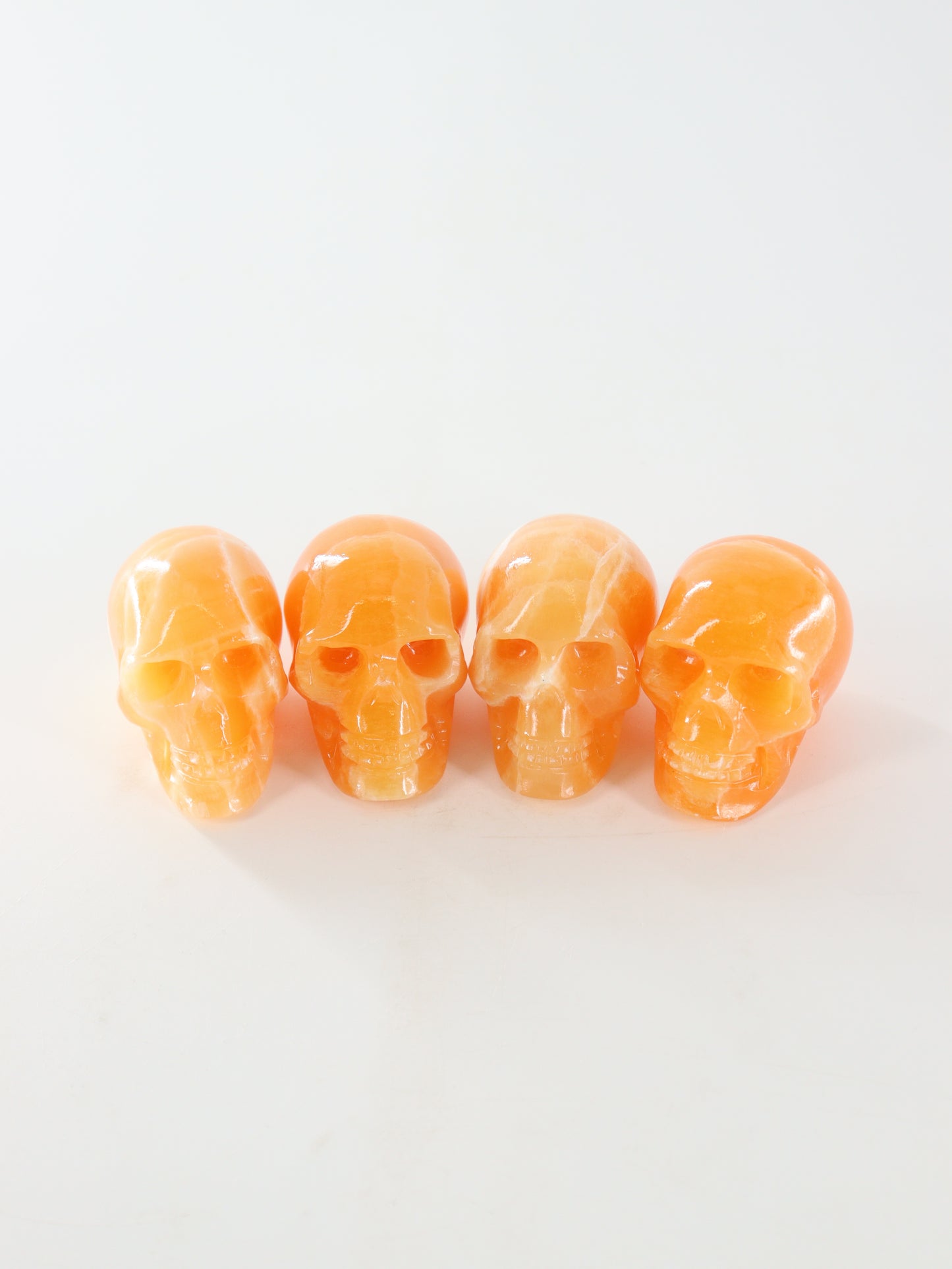 Orange Calcite Skulls Set of 4 - Expert Wholesale and Supplier of Wholesale Crystals & Bulk Gemstones, ["Calcite","Orange Calcite","Skulls"]