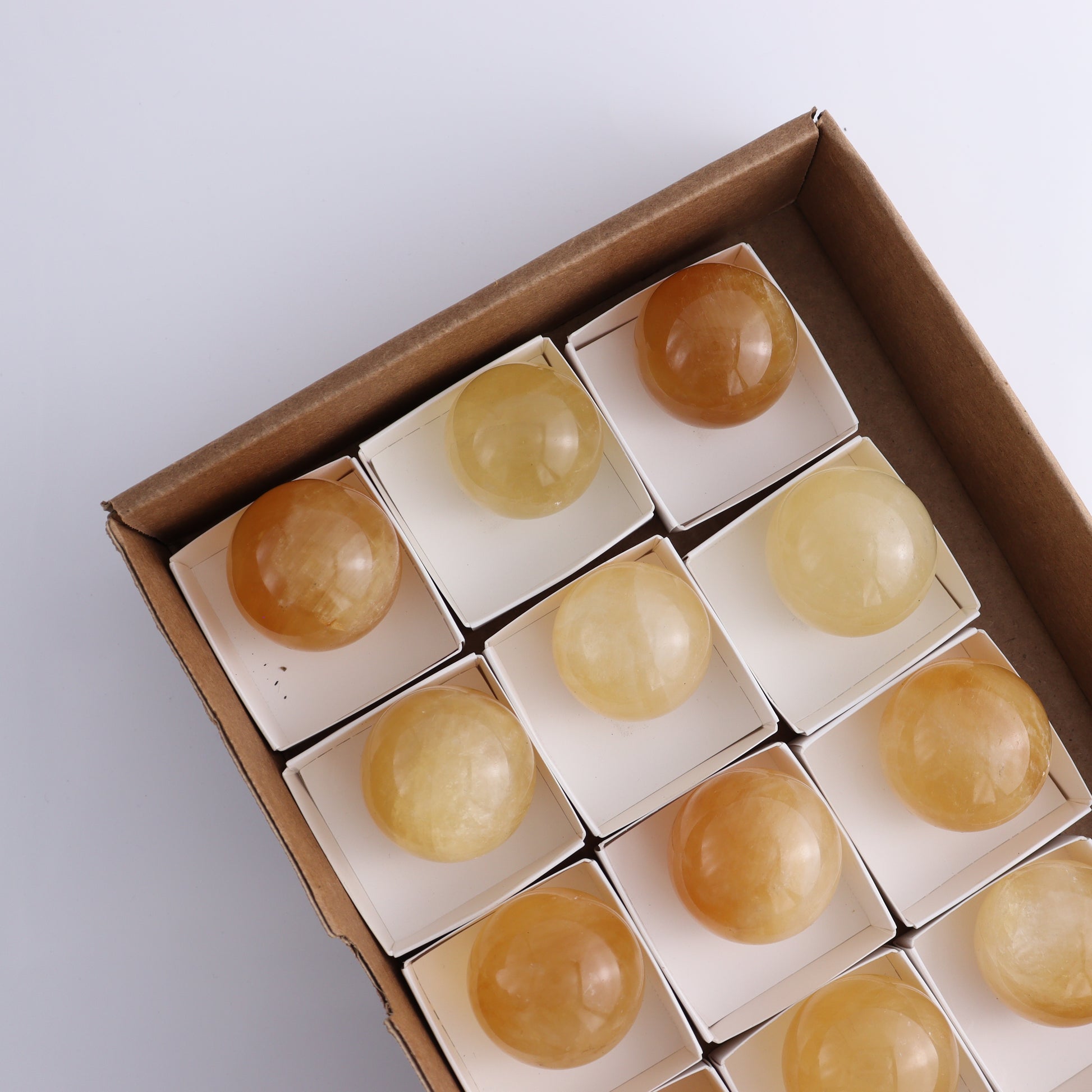 Honey Calcite Spheres Set of 12 - Expert Wholesale and Supplier of Wholesale Crystals & Bulk Gemstones, ["Calcite","Honey Calcite","Mexico","Spheres"]
