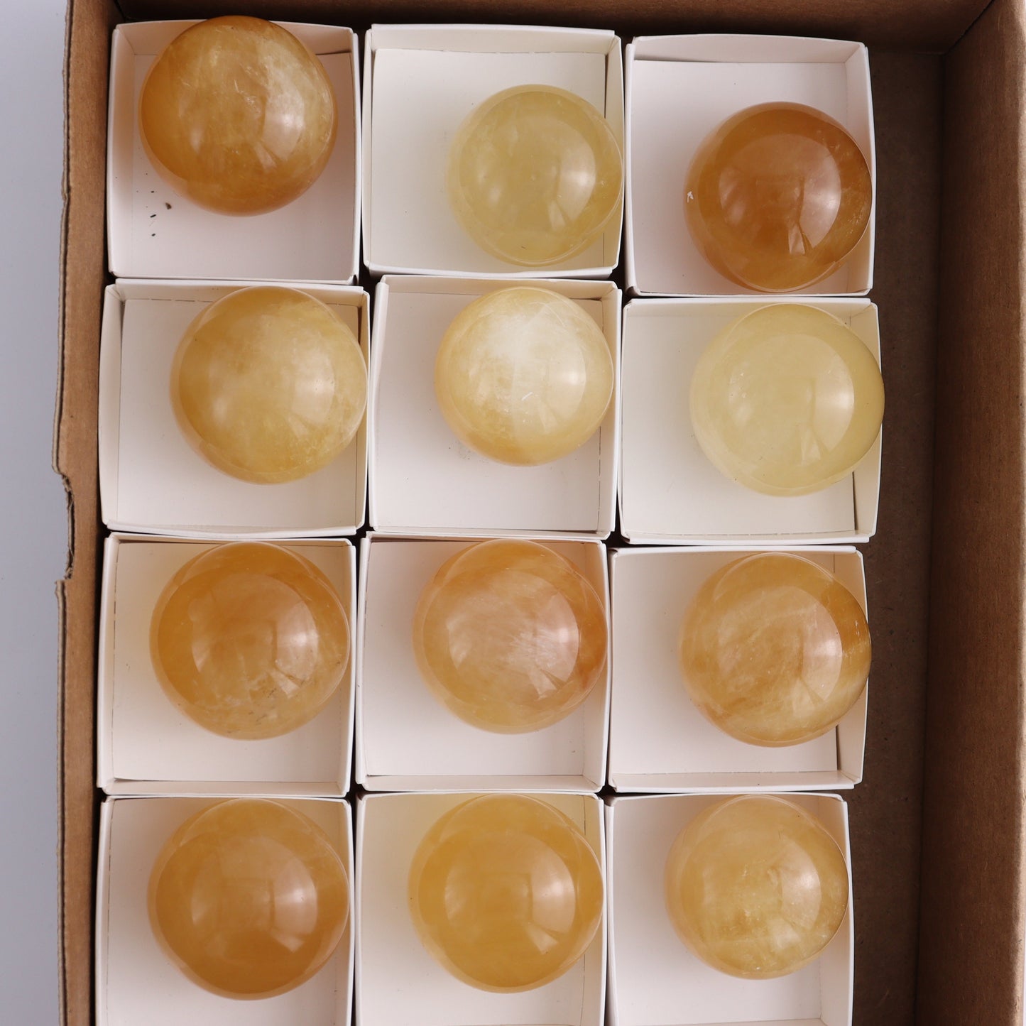 Honey Calcite Spheres Set of 12 - Expert Wholesale and Supplier of Wholesale Crystals & Bulk Gemstones, ["Calcite","Honey Calcite","Mexico","Spheres"]