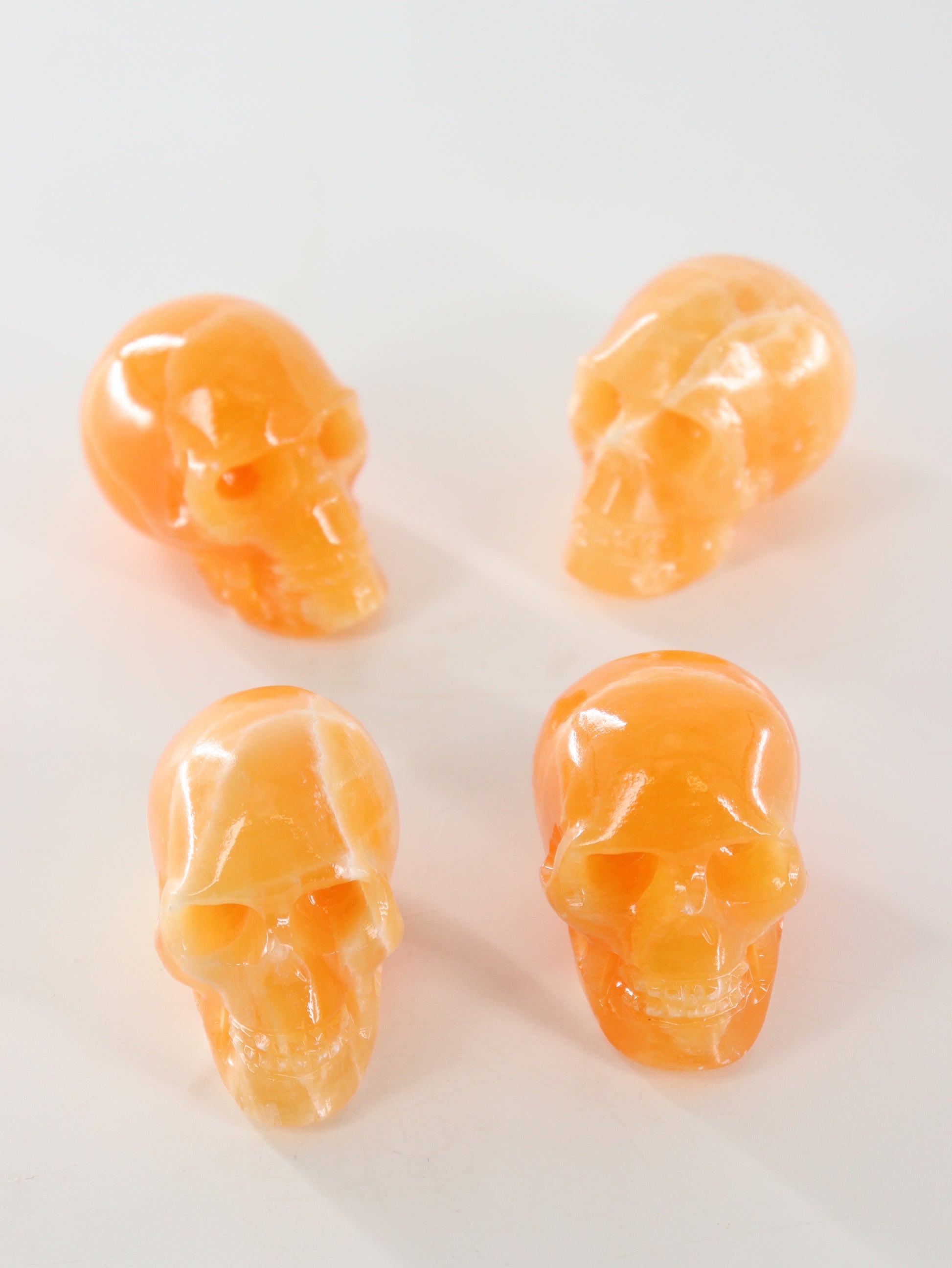 Orange Calcite Skulls Set of 4 - Expert Wholesale and Supplier of Wholesale Crystals & Bulk Gemstones, ["Calcite","Orange Calcite","Skulls"]