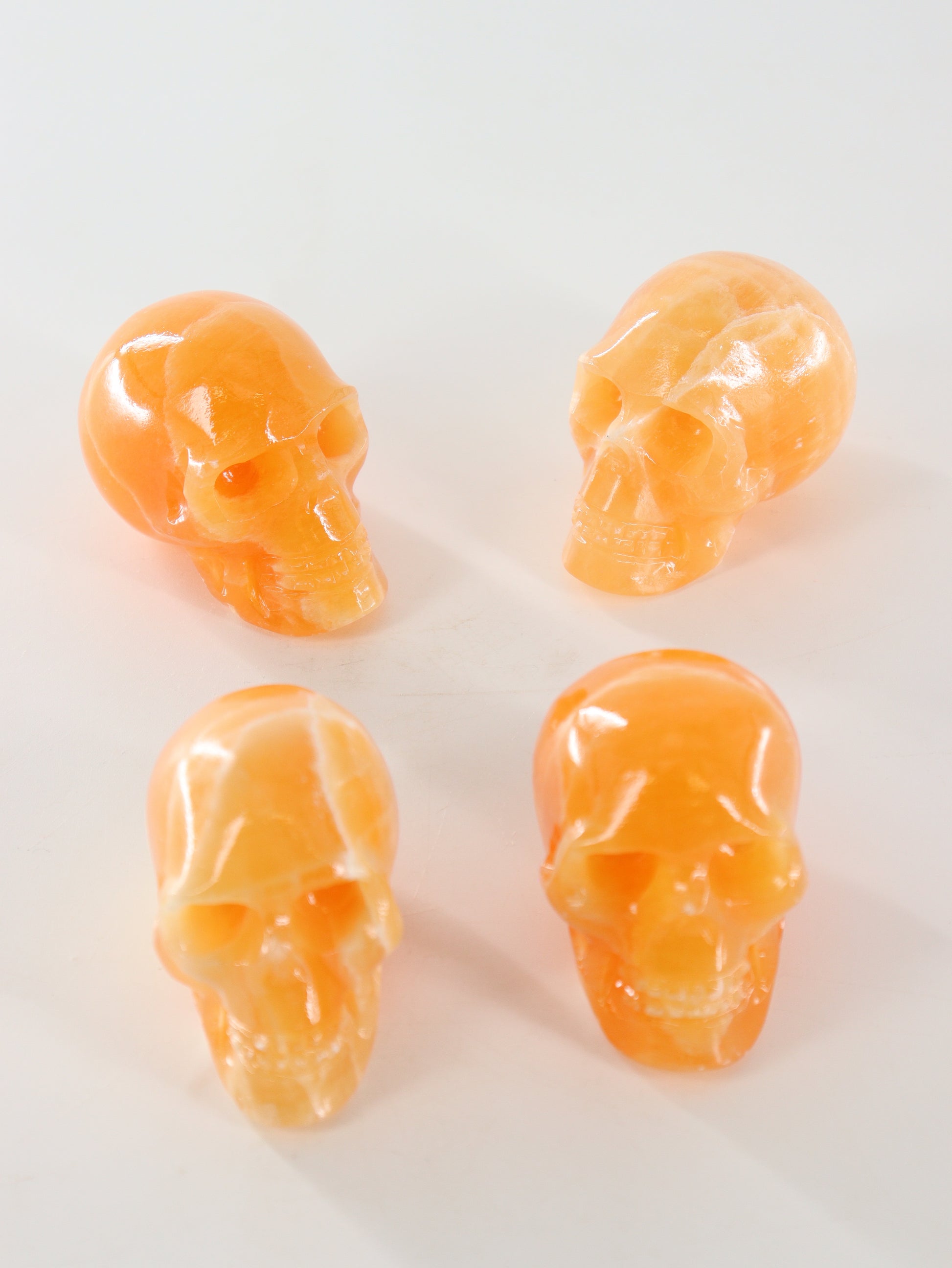 Orange Calcite Skulls Set of 4 - Expert Wholesale and Supplier of Wholesale Crystals & Bulk Gemstones, ["Calcite","Orange Calcite","Skulls"]