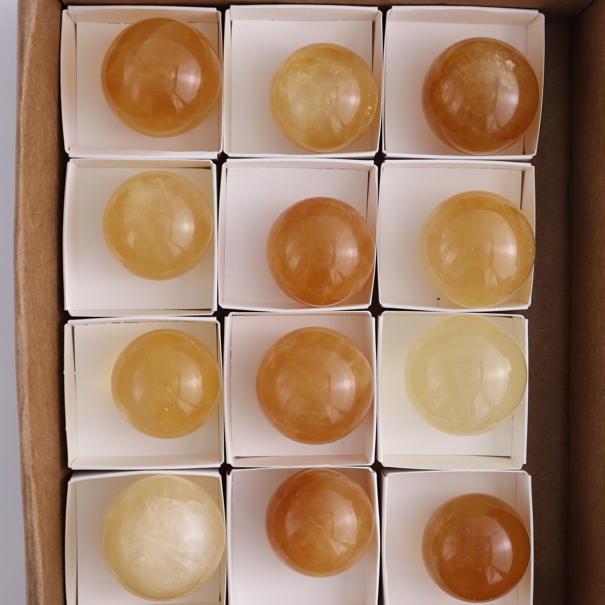 Honey Calcite Spheres Set of 12 - Expert Wholesale and Supplier of Wholesale Crystals & Bulk Gemstones, ["Calcite","Honey Calcite","Mexico","Spheres"]