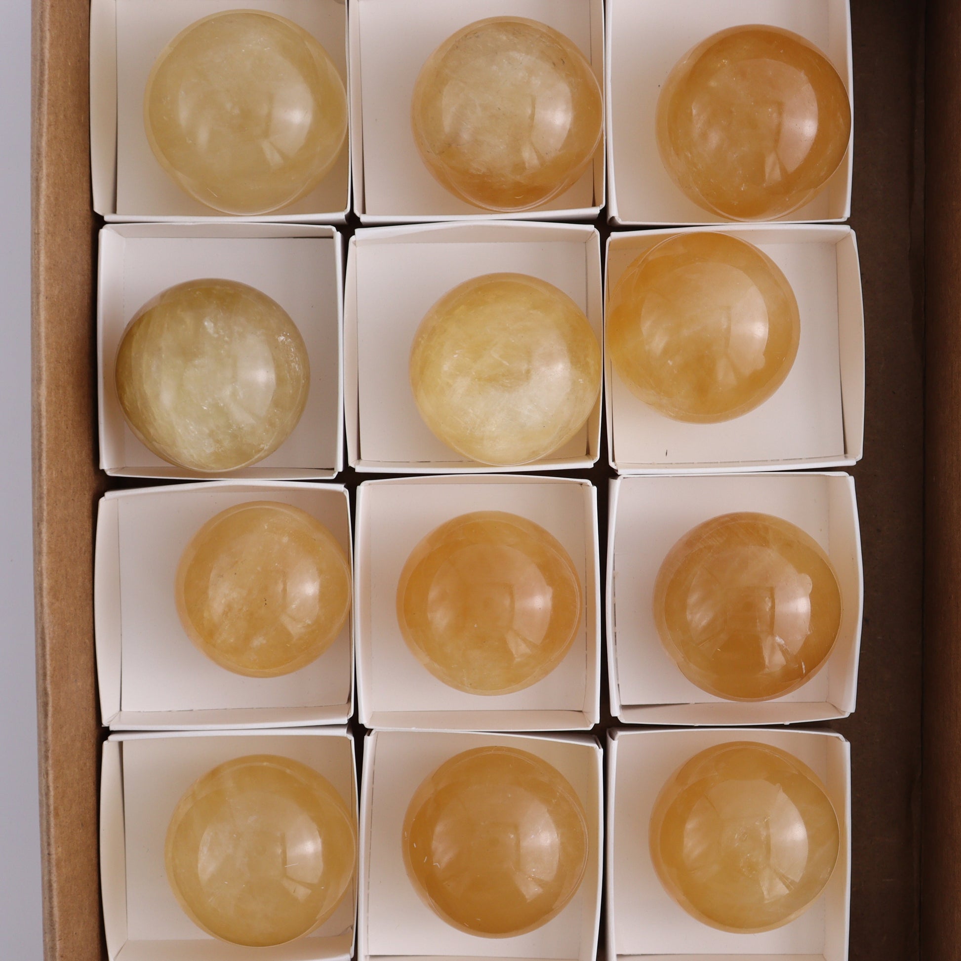 Honey Calcite Spheres Set of 12 - Expert Wholesale and Supplier of Wholesale Crystals & Bulk Gemstones, ["Calcite","Honey Calcite","Mexico","Spheres"]