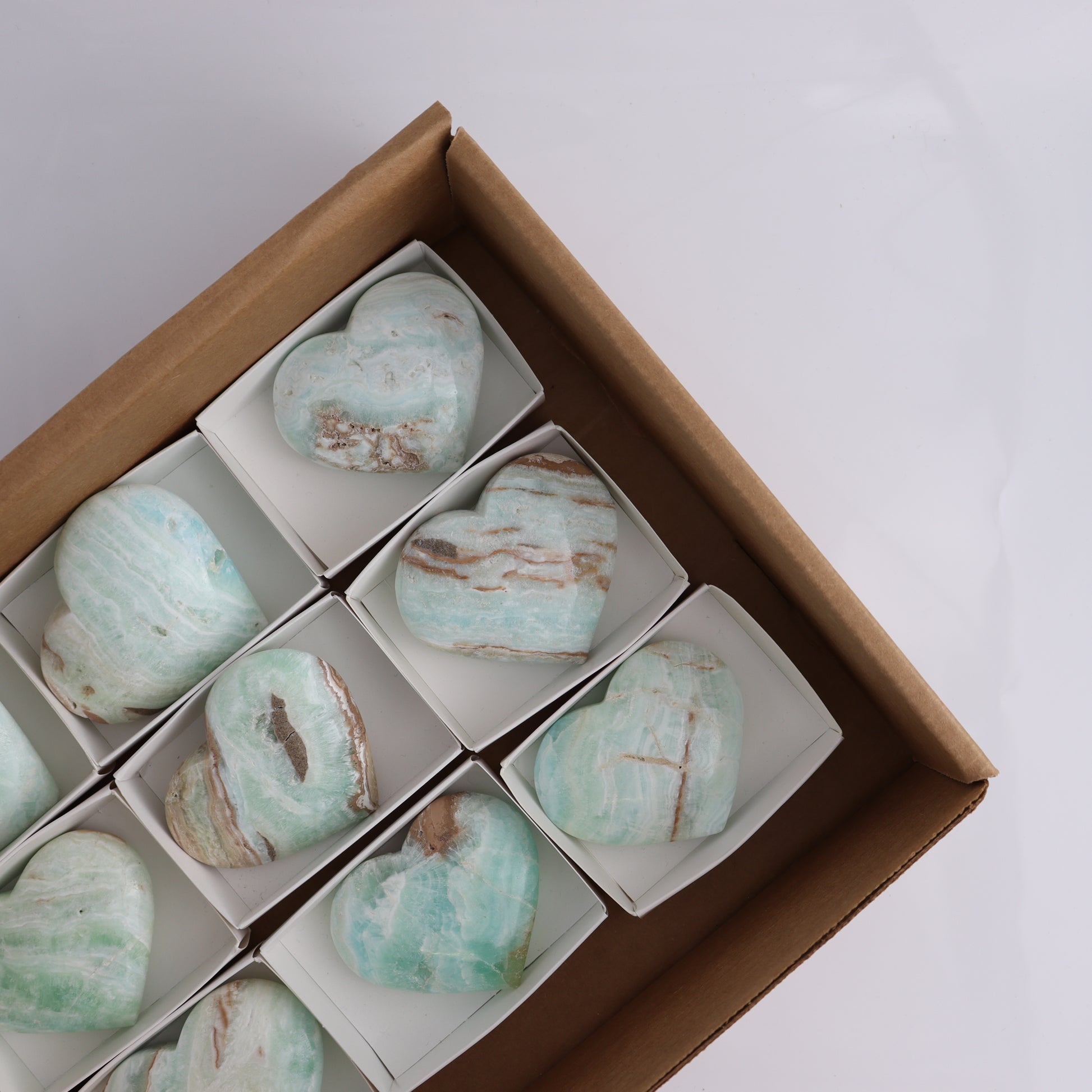 Caribbean Calcite Hearts Flat of 9 - Expert Wholesale and Supplier of Wholesale Crystals & Bulk Gemstones, ["Caribbean Calcite","Hearts","Madagascar"]