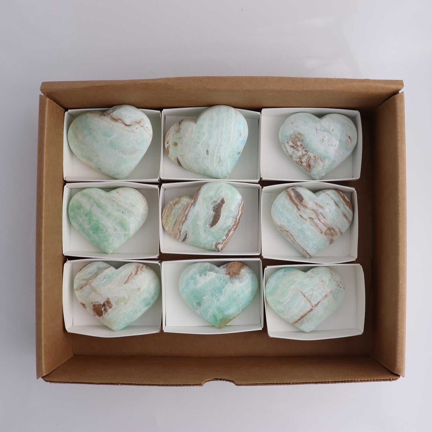 Caribbean Calcite Hearts Flat of 9 - Expert Wholesale and Supplier of Wholesale Crystals & Bulk Gemstones, ["Caribbean Calcite","Hearts","Madagascar"]