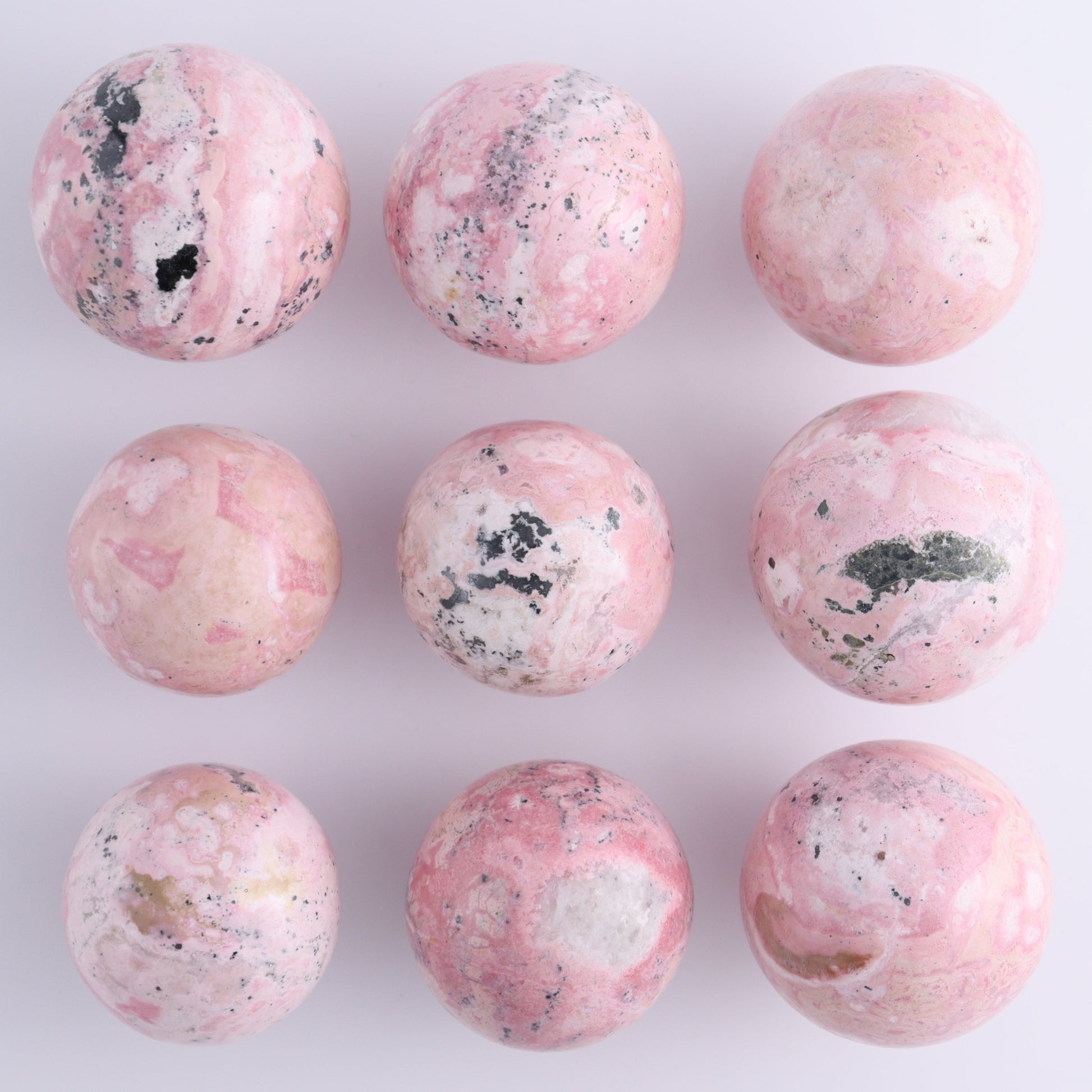 Rhodonite Spheres Set of 9 - Expert Wholesale and Supplier of Wholesale Crystals & Bulk Gemstones, ["Peru","Rhodonite","Spheres"]