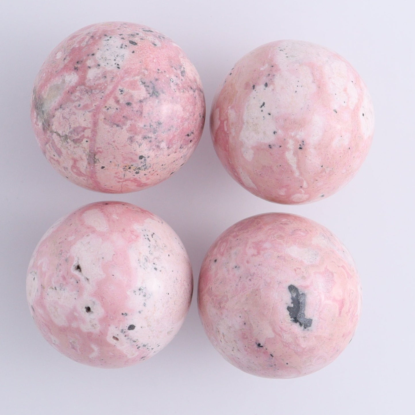Rhodonite Spheres Set of 9 - Expert Wholesale and Supplier of Wholesale Crystals & Bulk Gemstones, ["Peru","Rhodonite","Spheres"]