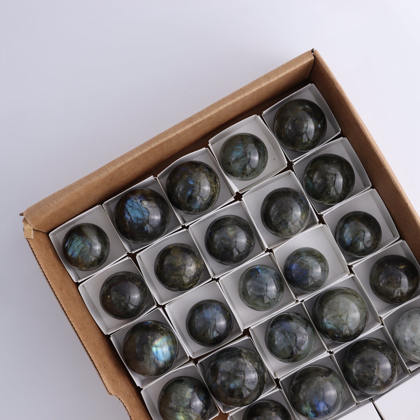 Labradorite Spheres Flat of 24 - Expert Wholesale and Supplier of Wholesale Crystals & Bulk Gemstones, ["Labradorite","Madagascar","Spheres"]